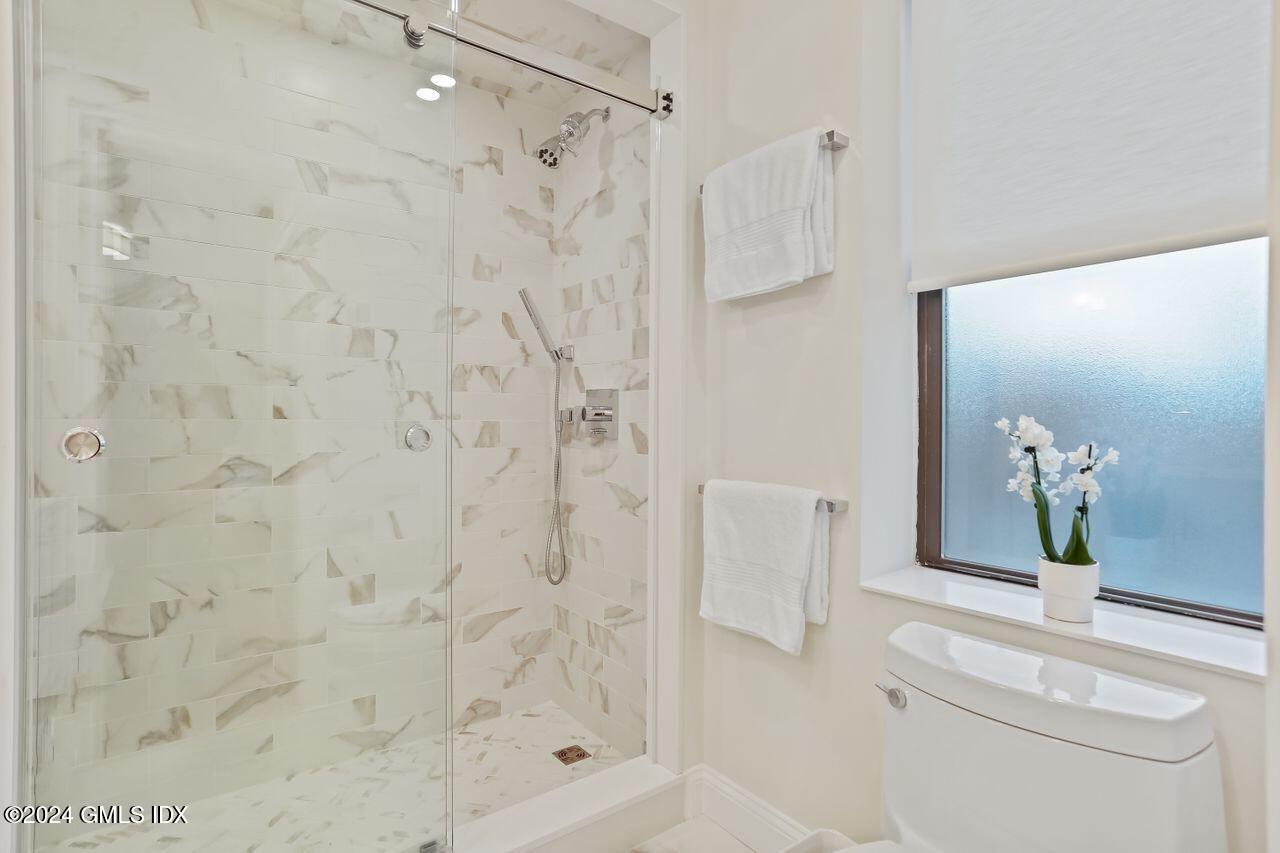 40 West Elm Street, Unit 3G Greenwich, CT 06830 - Photo 16 of 20 a bathroom with a shower a toilet and a shower