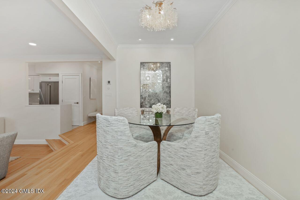 40 West Elm Street, Unit 3G Greenwich, CT 06830 - Photo 4 of 20 a living room with furniture and a chandelier