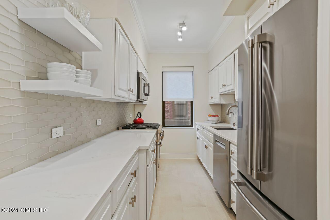 40 West Elm Street, Unit 3G Greenwich, CT 06830 - Photo 5 of 20 a kitchen with white cabinets and white appliances