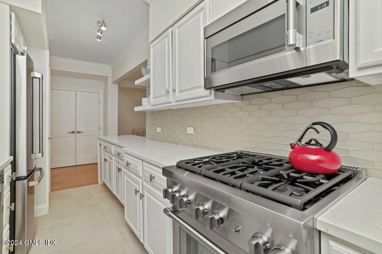 40 West Elm Street, Unit 3G Greenwich, CT 06830 - Photo 6 of 20 a kitchen with stove top oven and cabinets