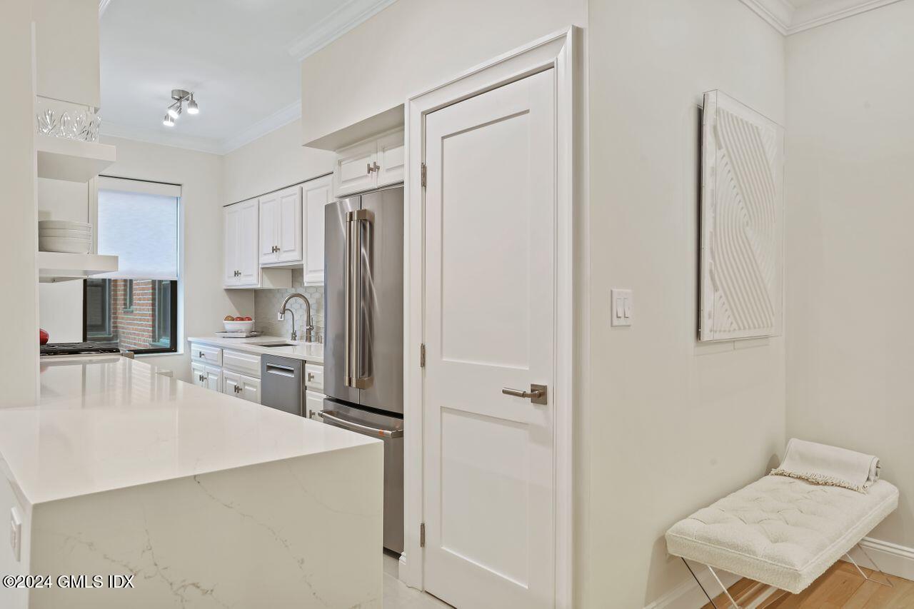 40 West Elm Street, Unit 3G Greenwich, CT 06830 - Photo 7 of 20 a kitchen with stainless steel appliances a refrigerator and a stove top oven