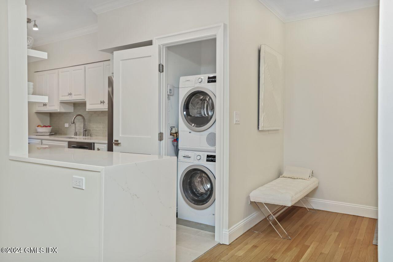 40 West Elm Street, Unit 3G Greenwich, CT 06830 - Photo 8 of 20 a view of a kitchen with fridge and wooden floor