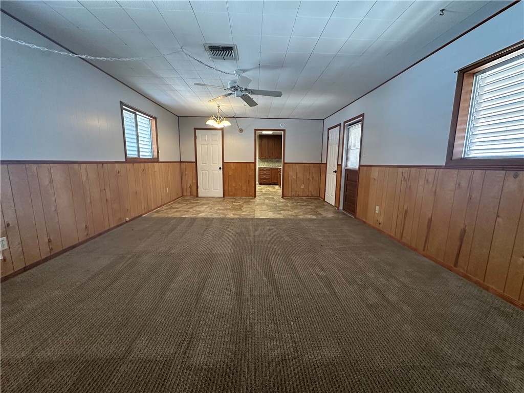1133 Austin Street Portland, TX 78374 - Photo 15 of 32 en empty room with wooden floor and windows