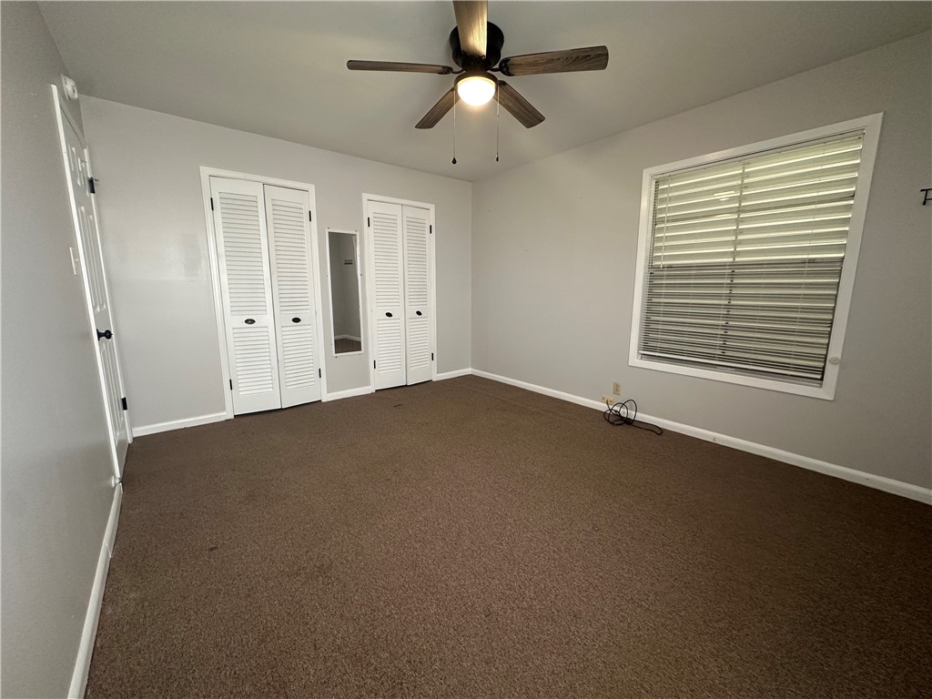 1133 Austin Street Portland, TX 78374 - Photo 21 of 32 en empty room with windows and fan