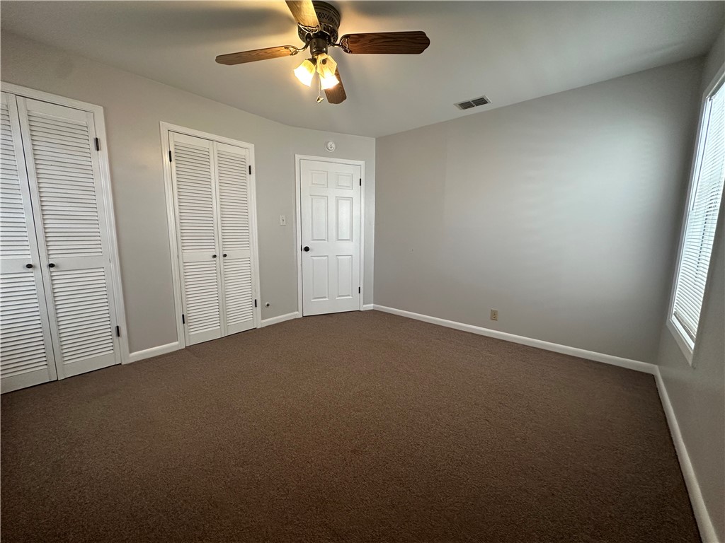 1133 Austin Street Portland, TX 78374 - Photo 25 of 32 an empty room with a window and a fan