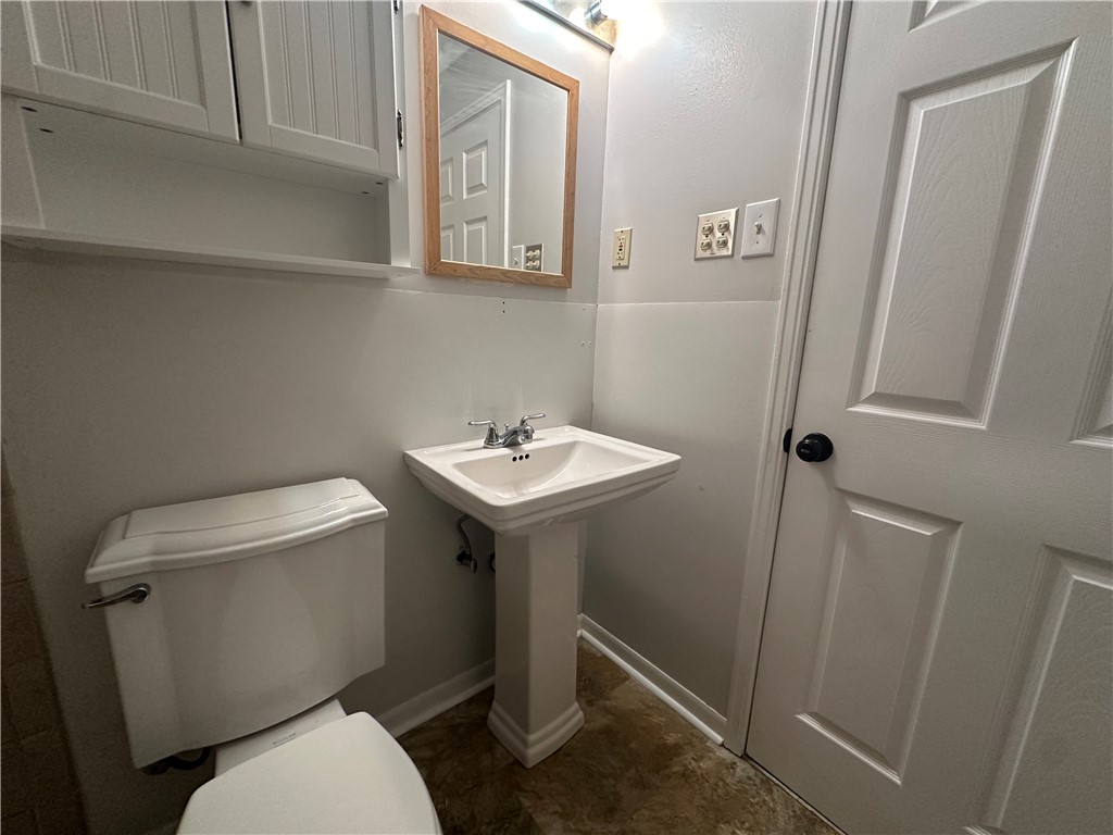 1133 Austin Street Portland, TX 78374 - Photo 28 of 32 a bathroom with a toilet sink and mirror