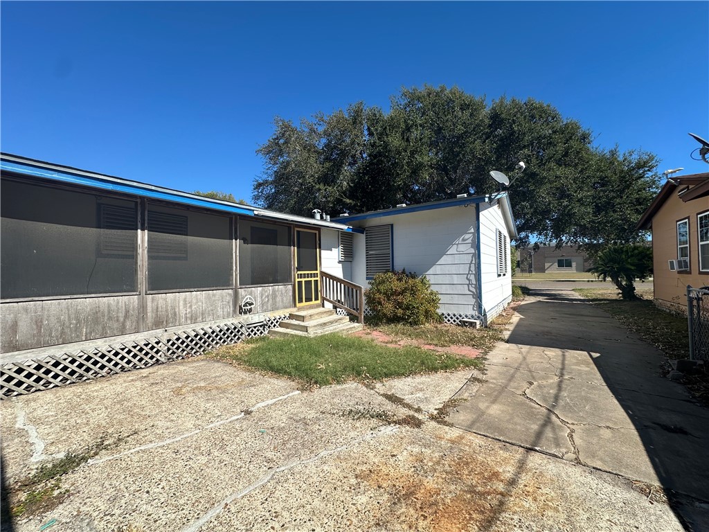1133 Austin Street Portland, TX 78374 - Photo 32 of 32 a front view of a house with a yard and garage
