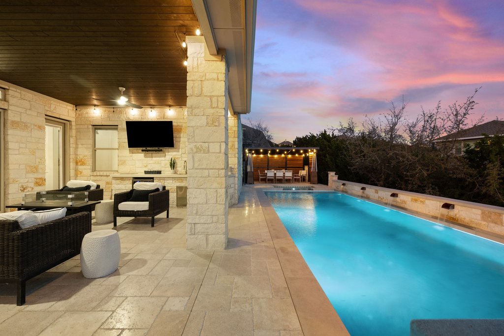 207 San Siro Cove Austin, TX 78738 - Photo 15 of 40 A true entertainer's backyard paradise featuring a beautiful outdoor pool and spa, a covered patio with an outdoor grill and cabana for dining al fresca!