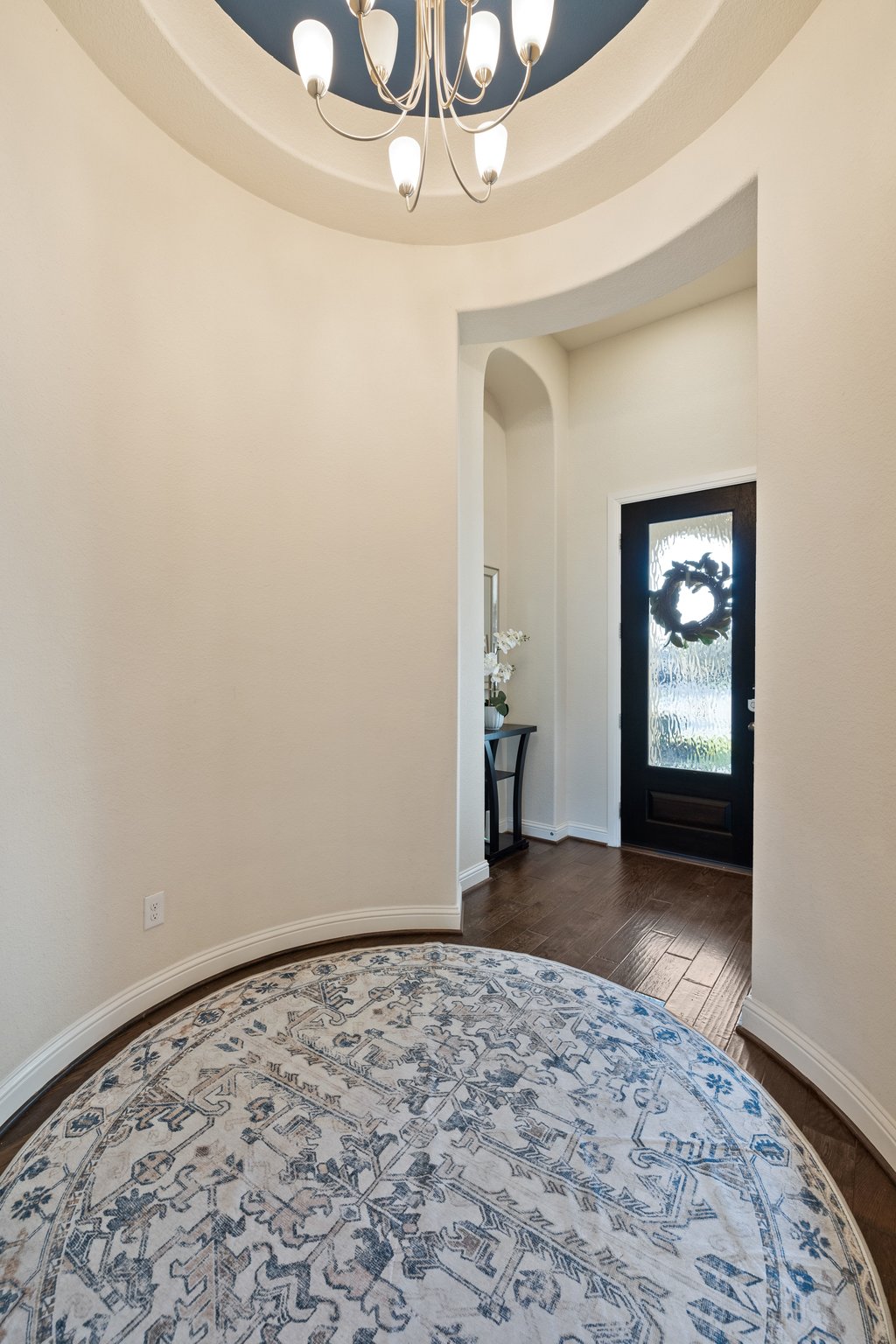 207 San Siro Cove Austin, TX 78738 - Photo 18 of 40 A grand foyer with soaring ceilings and a rounded entryway that creates an elegant first impression.