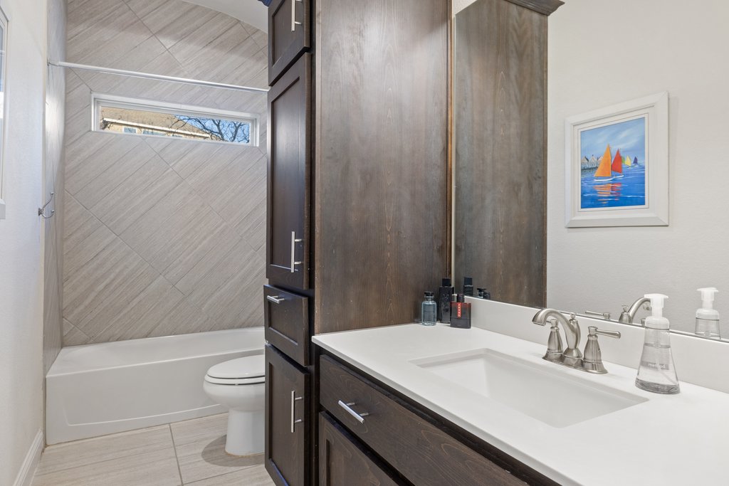 207 San Siro Cove Austin, TX 78738 - Photo 26 of 40 The full bath showcases gorgeous cabinetry with ample storage and tile to the arched ceiling.