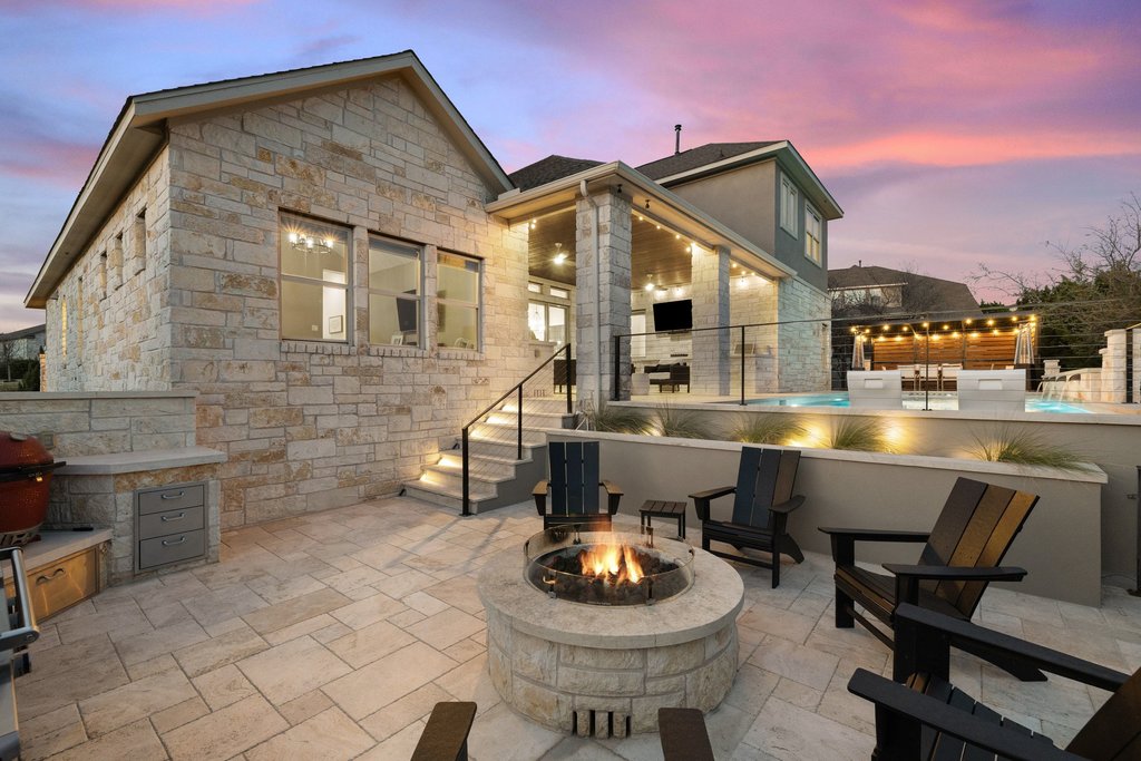 207 San Siro Cove Austin, TX 78738 - Photo 3 of 40 Enjoy the cozy fire pit and grilling area. The multiple outdoor living areas offer an abundance of dining, seating, and lounging for all!