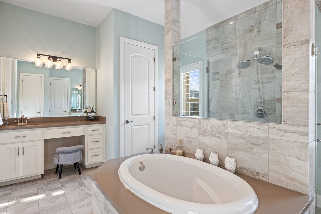 207 San Siro Cove Austin, TX 78738 - Photo 9 of 40 Primary bathroom with two vanities, a separate oversized walk-in shower, and a soaking tub give the essence of a spa in your own home.