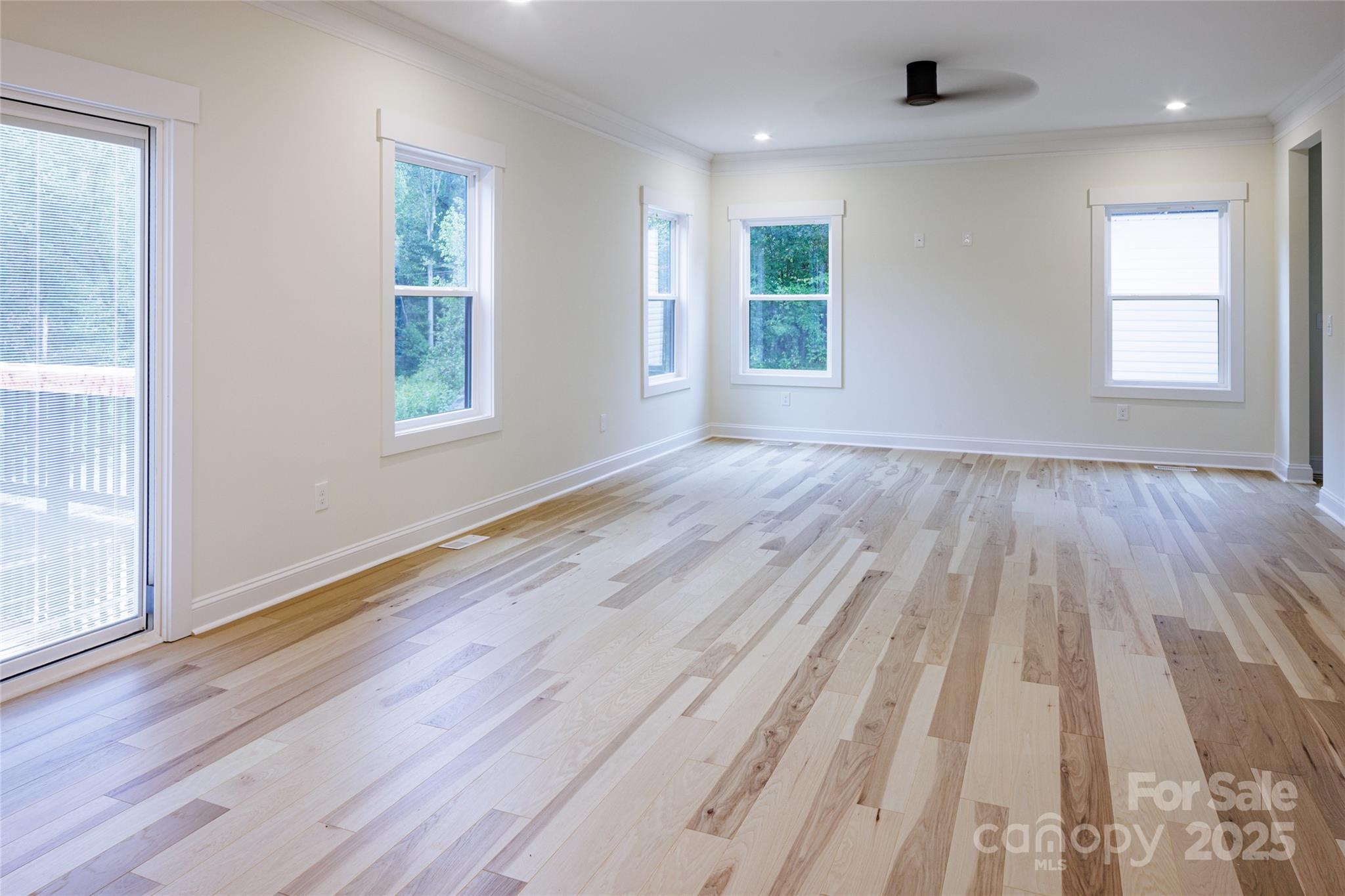 5891 Vinewood Road Davidson, NC 28036 - Photo 11 of 22 an empty room with wooden floor and windows