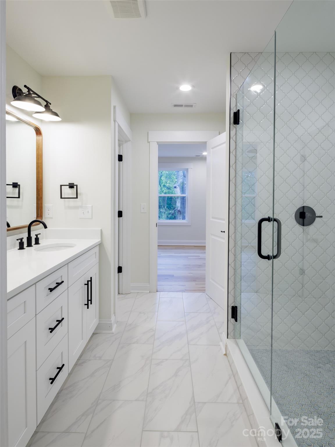 5891 Vinewood Road Davidson, NC 28036 - Photo 18 of 22 a bathroom with a double vanity sink mirror and shower