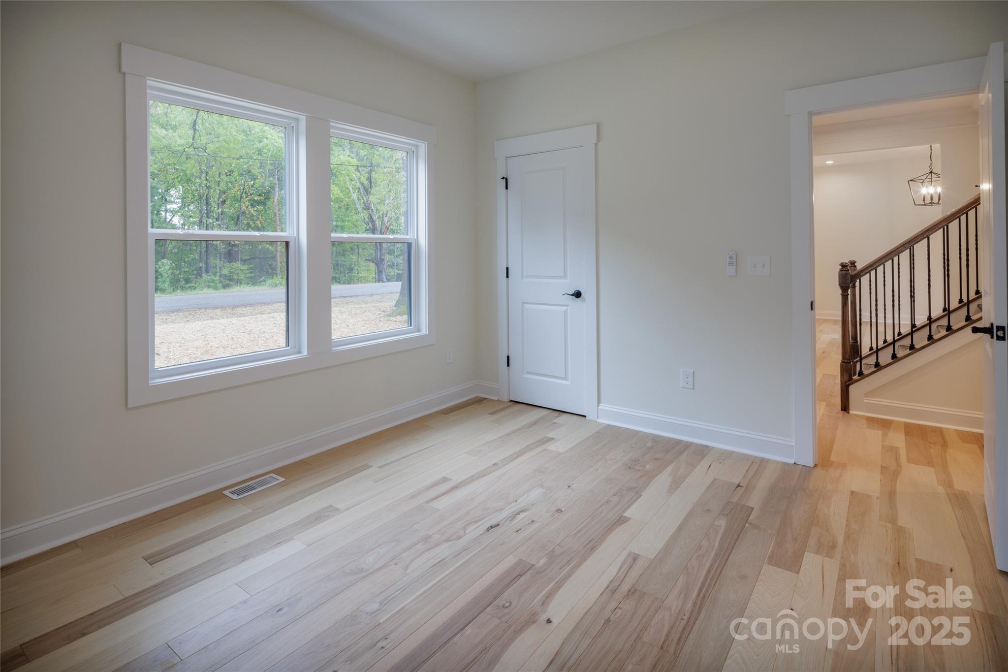 5891 Vinewood Road Davidson, NC 28036 - Photo 19 of 22 a view of an empty room with wooden floor and a window