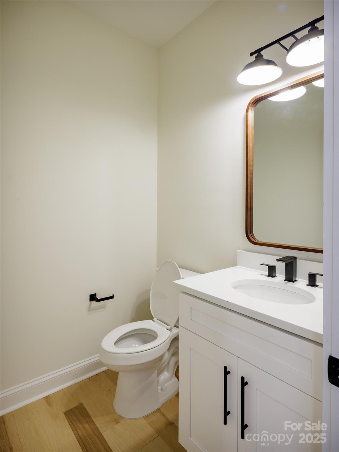 5891 Vinewood Road Davidson, NC 28036 - Photo 20 of 22 a bathroom with a toilet sink and mirror