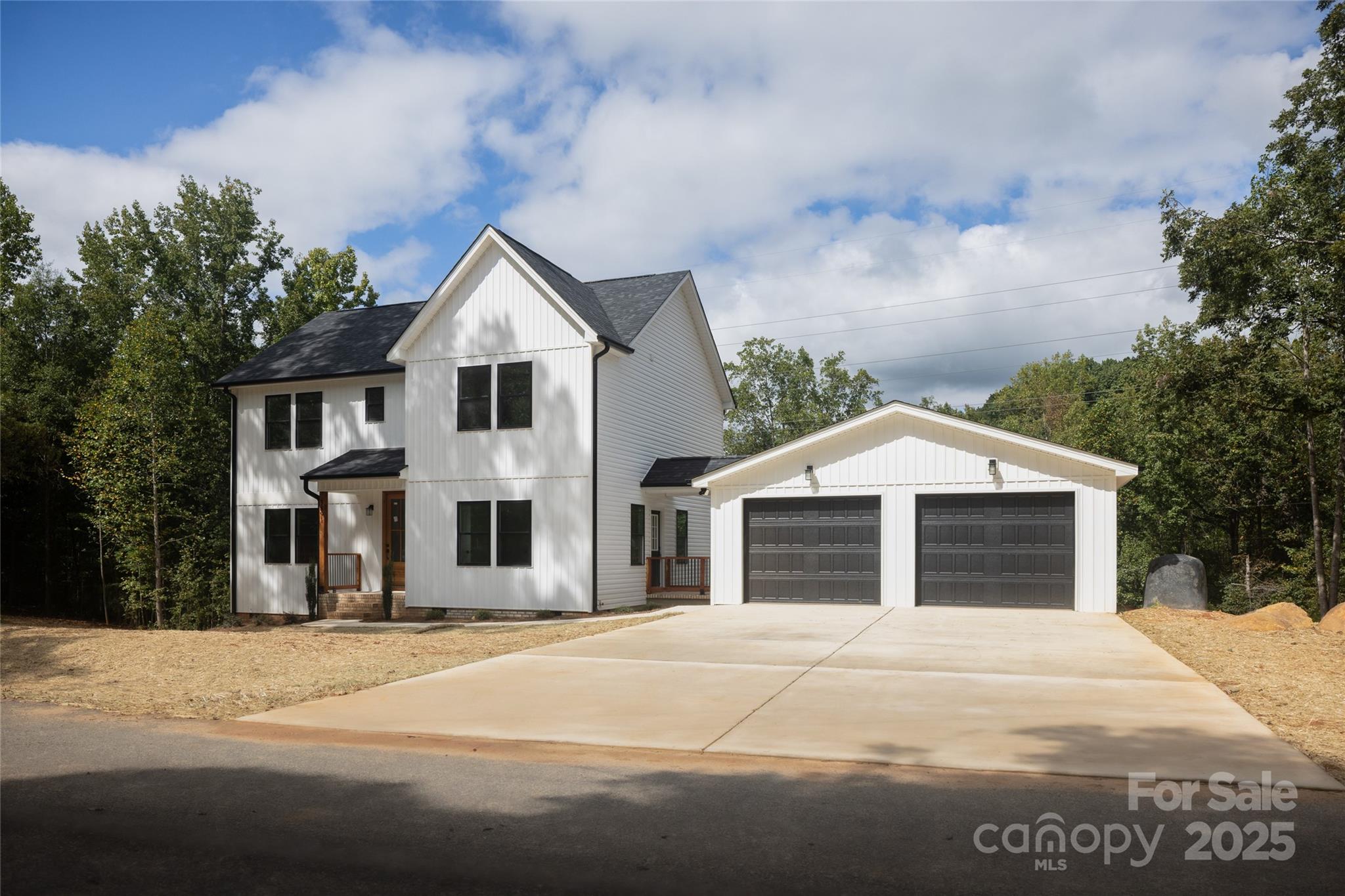 5891 Vinewood Road Davidson, NC 28036 - Photo 3 of 22 a front view of a house with a yard and garage