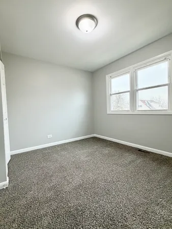 an empty room with a empty space and windows