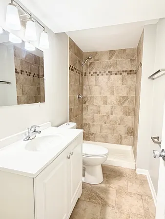 a bathroom with a sink toilet and shower