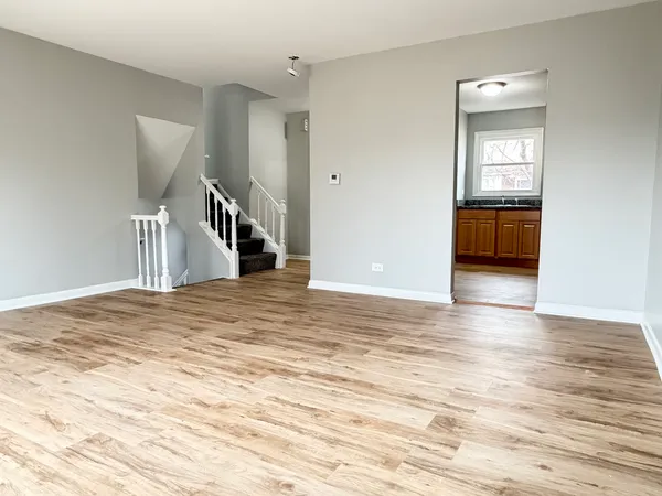 a view of a room with wooden floor and stairs