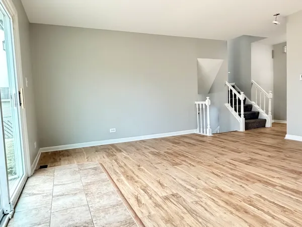 a view of a bedroom with a balcony and natural light
