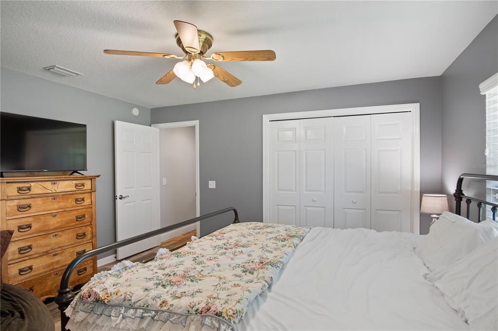 9045 Lake Hatchineha Road Kissimmee, FL 34759 - Photo 36 of 47 a bedroom with a bed and a flat screen tv