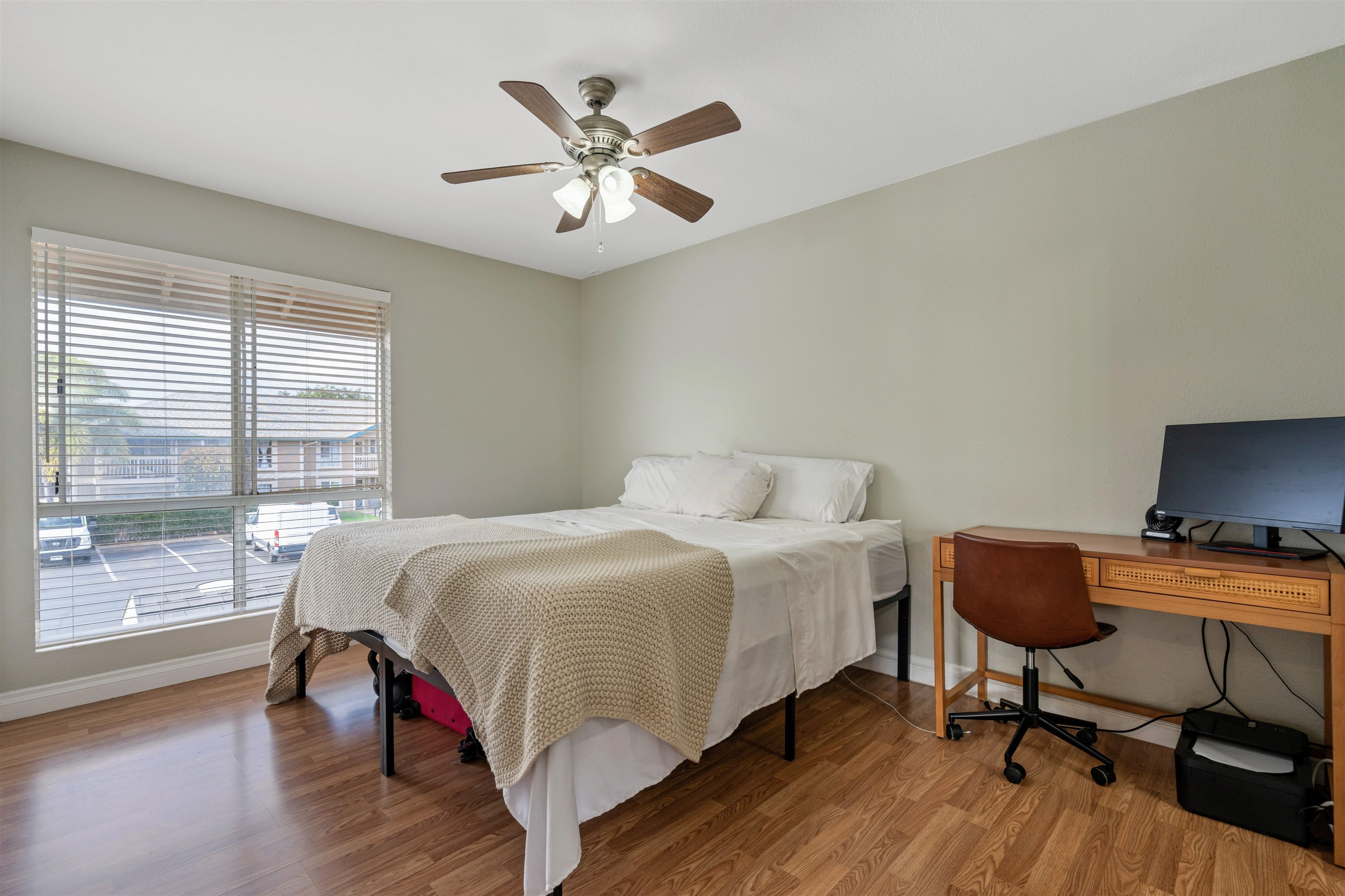 480 Kenolio Road, Unit 11206 Kihei, HI 96753 - Photo 17 of 31 a bedroom with a bed and a desk