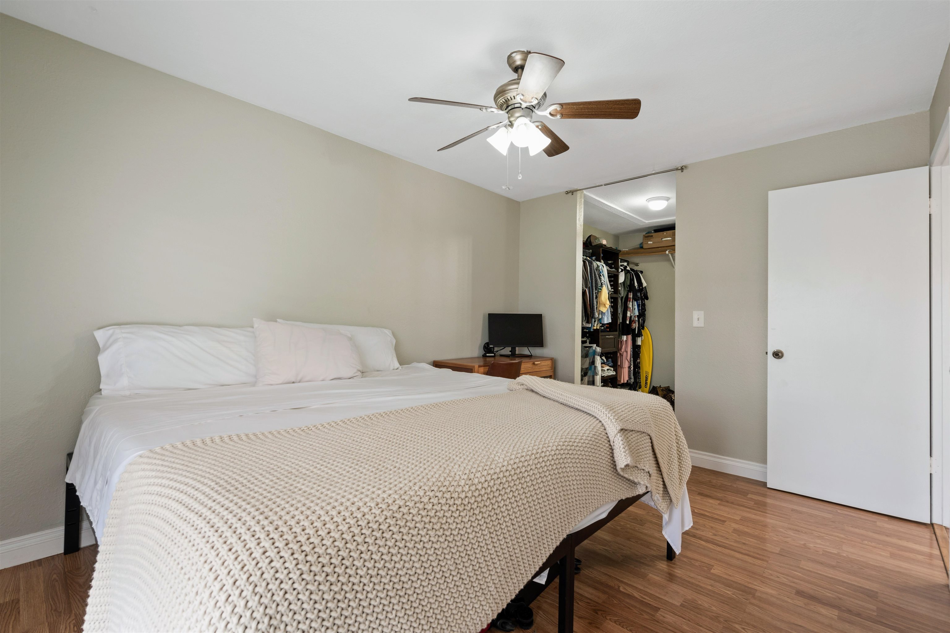 480 Kenolio Road, Unit 11206 Kihei, HI 96753 - Photo 18 of 31 a bedroom with a large bed and a chandelier