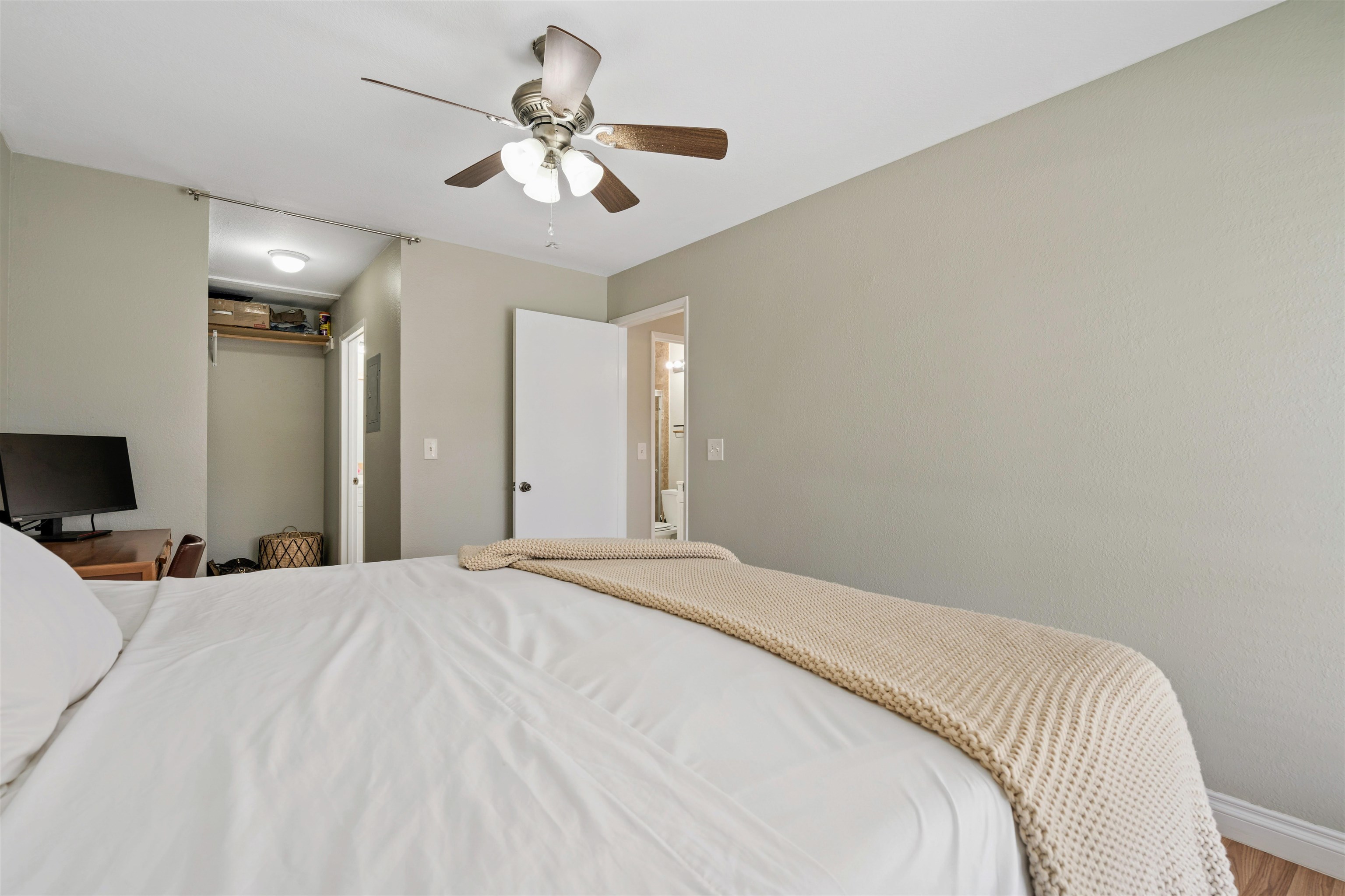 480 Kenolio Road, Unit 11206 Kihei, HI 96753 - Photo 19 of 31 a bedroom with a large bed and a chandelier