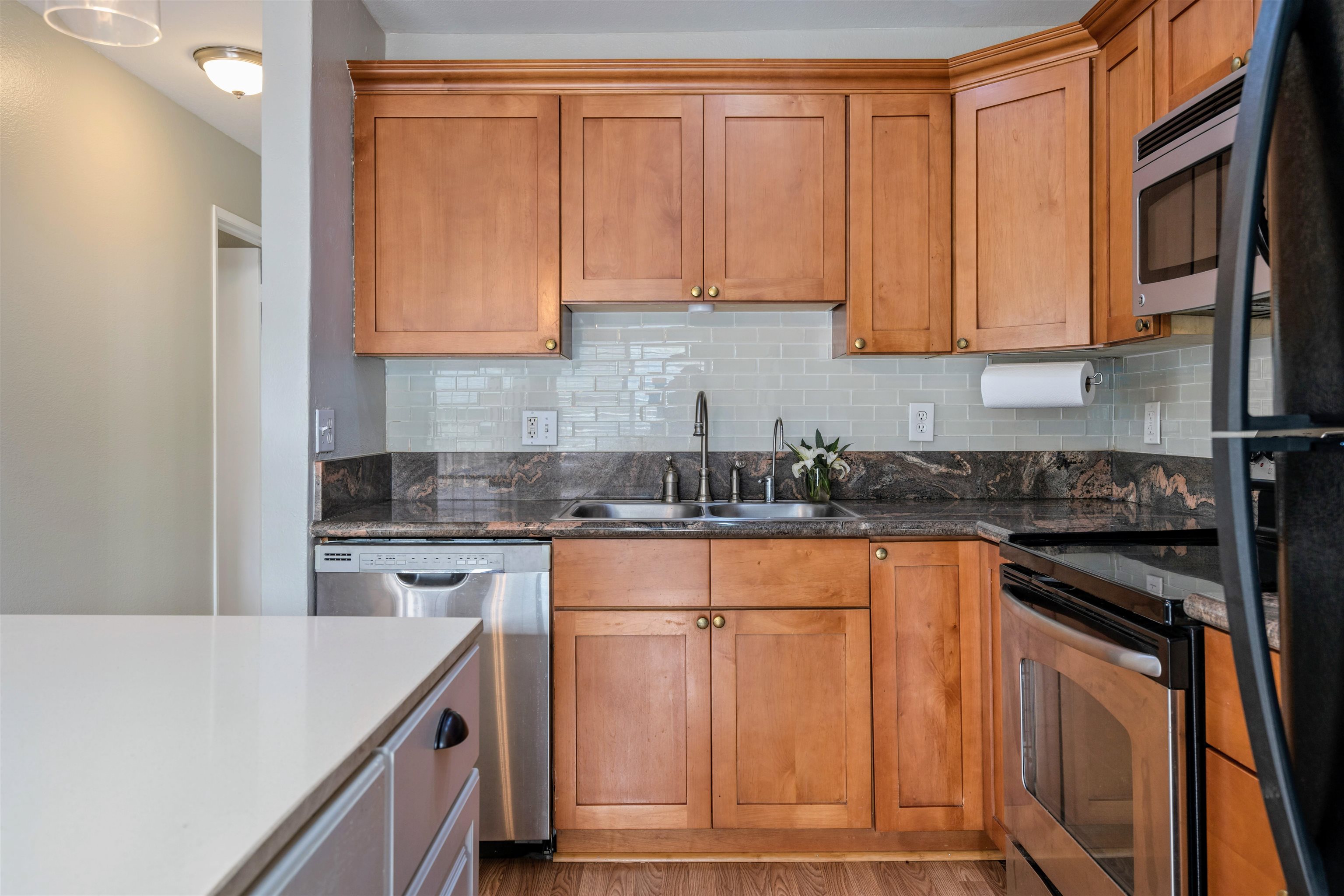 480 Kenolio Road, Unit 11206 Kihei, HI 96753 - Photo 3 of 31 a kitchen with stainless steel appliances granite countertop a stove a sink dishwasher and a refrigerator