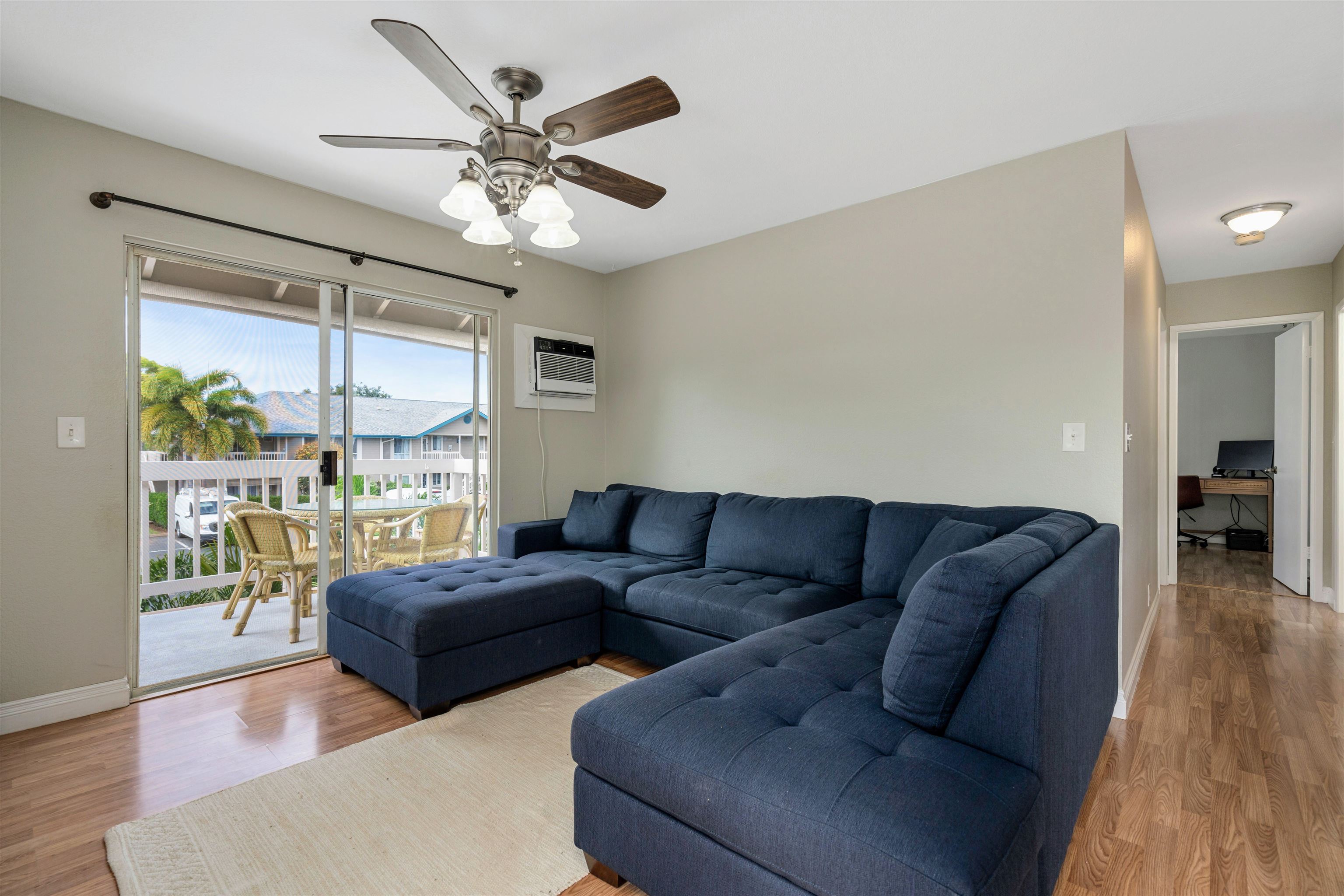 480 Kenolio Road, Unit 11206 Kihei, HI 96753 - Photo 5 of 31 a living room with furniture and a large window with wooden floor