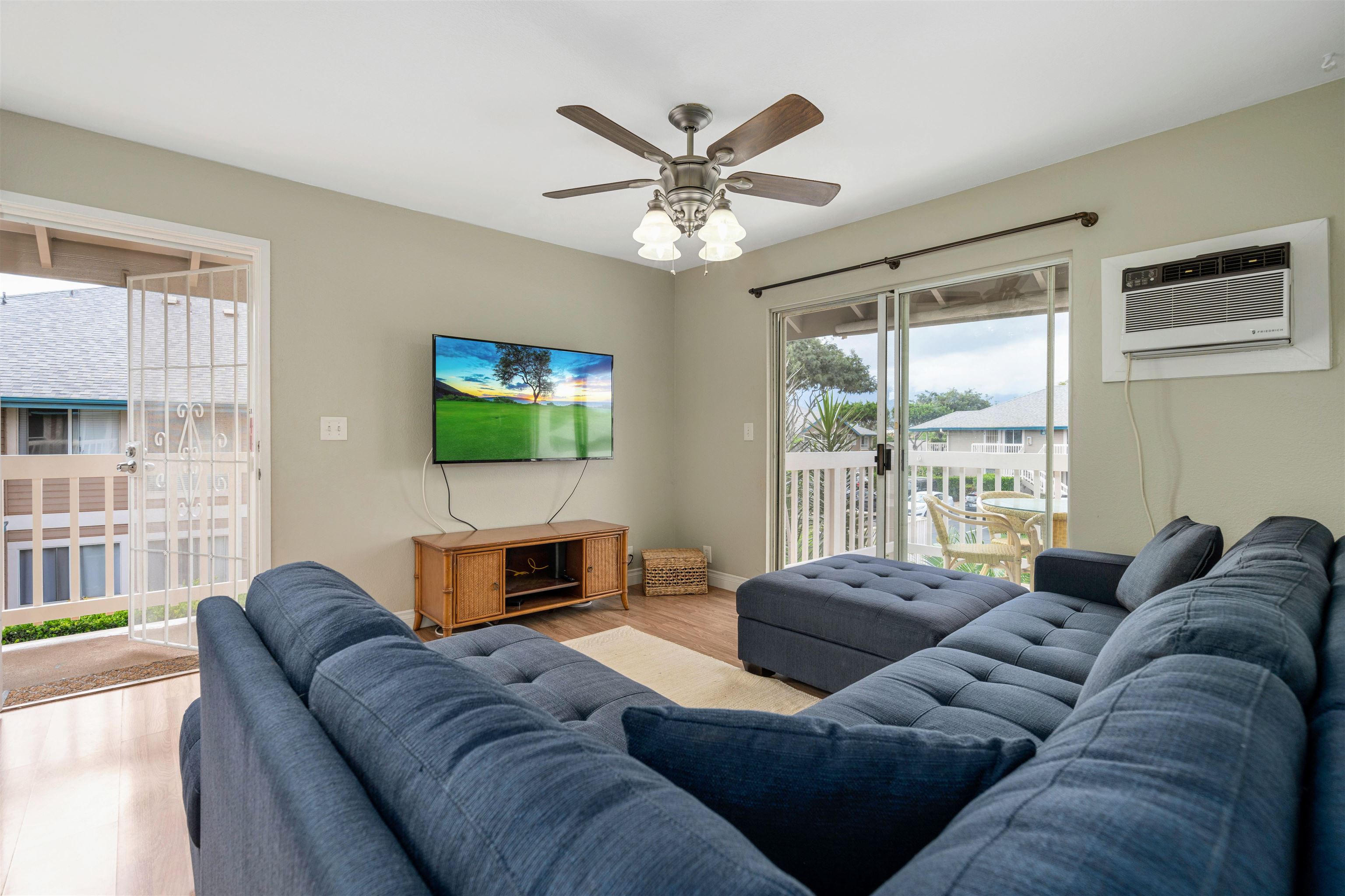 480 Kenolio Road, Unit 11206 Kihei, HI 96753 - Photo 6 of 31 a living room with furniture a large window and a flat screen tv