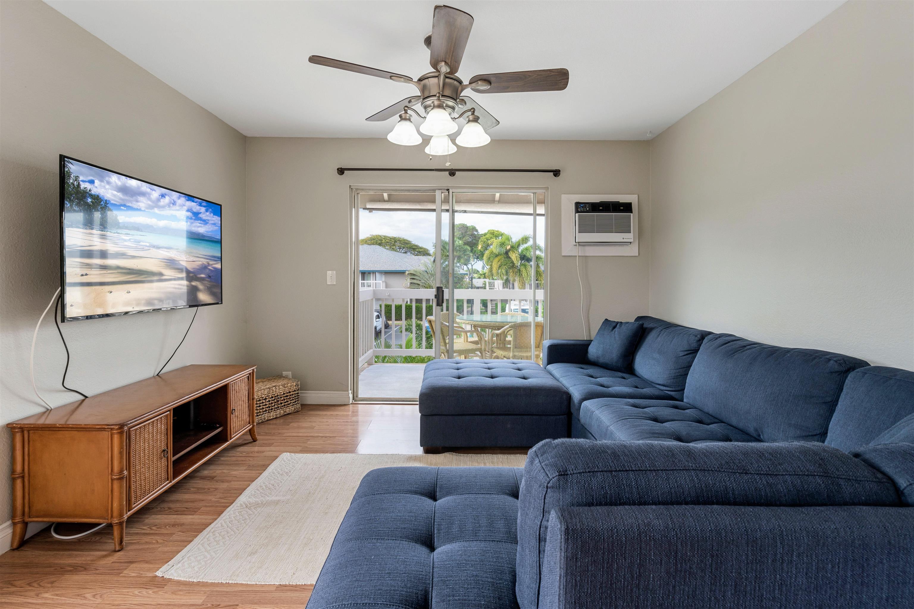 480 Kenolio Road, Unit 11206 Kihei, HI 96753 - Photo 8 of 31 a living room with furniture a chandelier and a large window