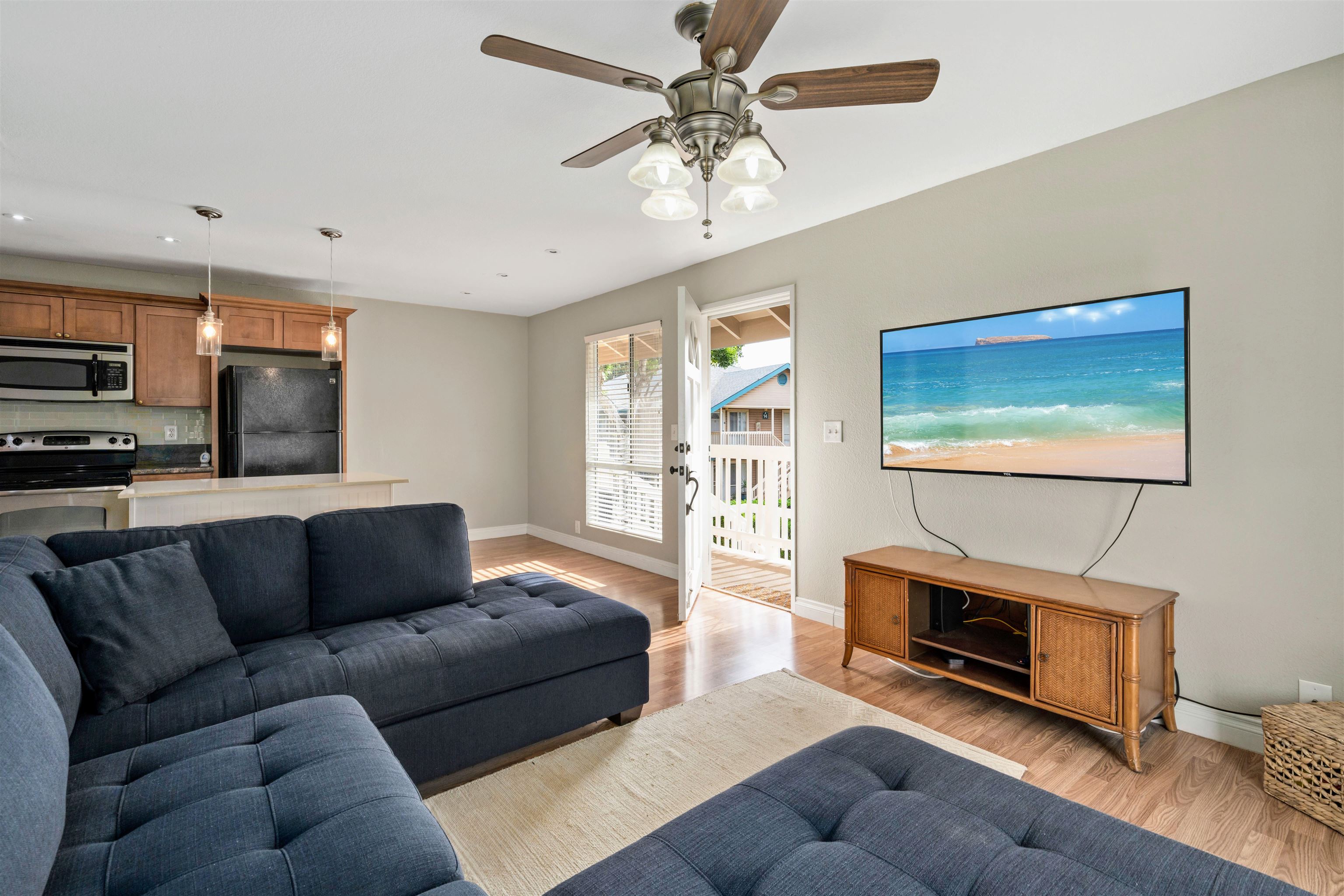 480 Kenolio Road, Unit 11206 Kihei, HI 96753 - Photo 10 of 31 a living room with furniture a flat screen tv and a fireplace