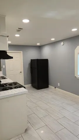 a kitchen with stainless steel appliances granite countertop a refrigerator a stove and a refrigerator