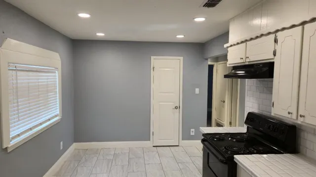a living room with stainless steel appliances kitchen island granite countertop furniture and a window
