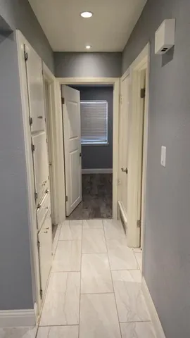 a bathroom with a glass shower door and a sink