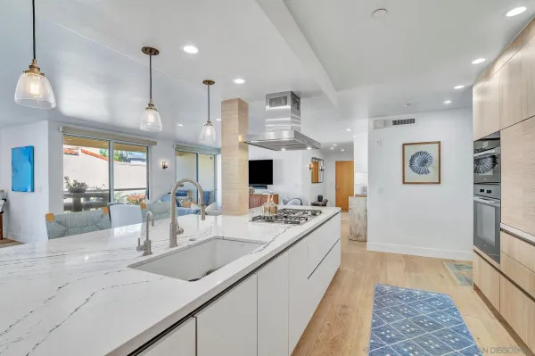 a living room with furniture and kitchen view