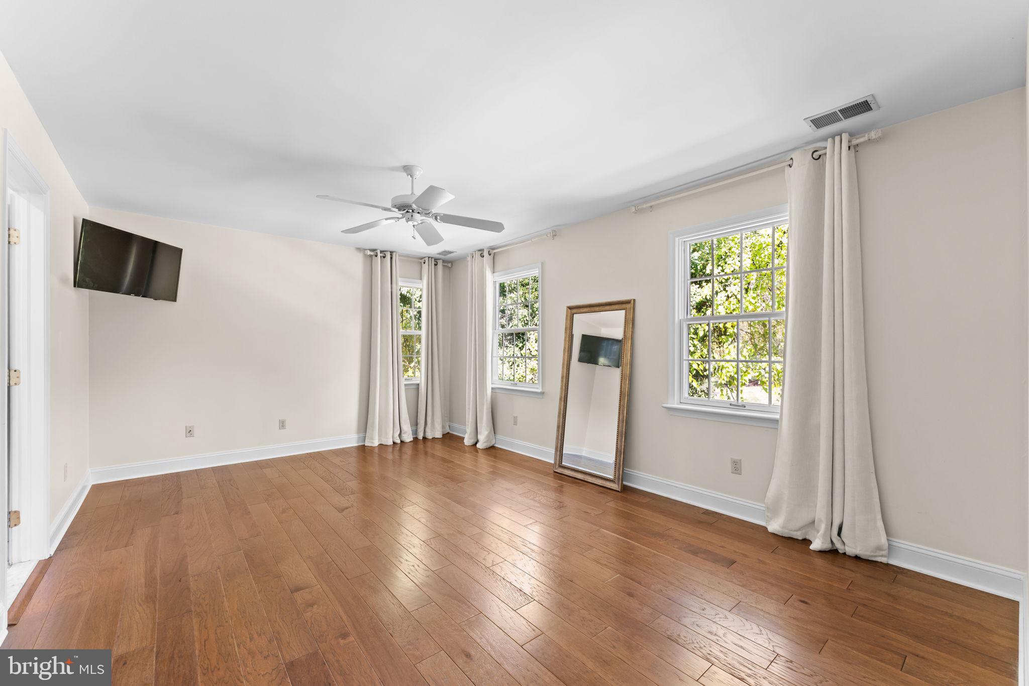 740 Monument Road Malvern, PA 19355 - Photo 33 of 51 an empty room with wooden floor and windows
