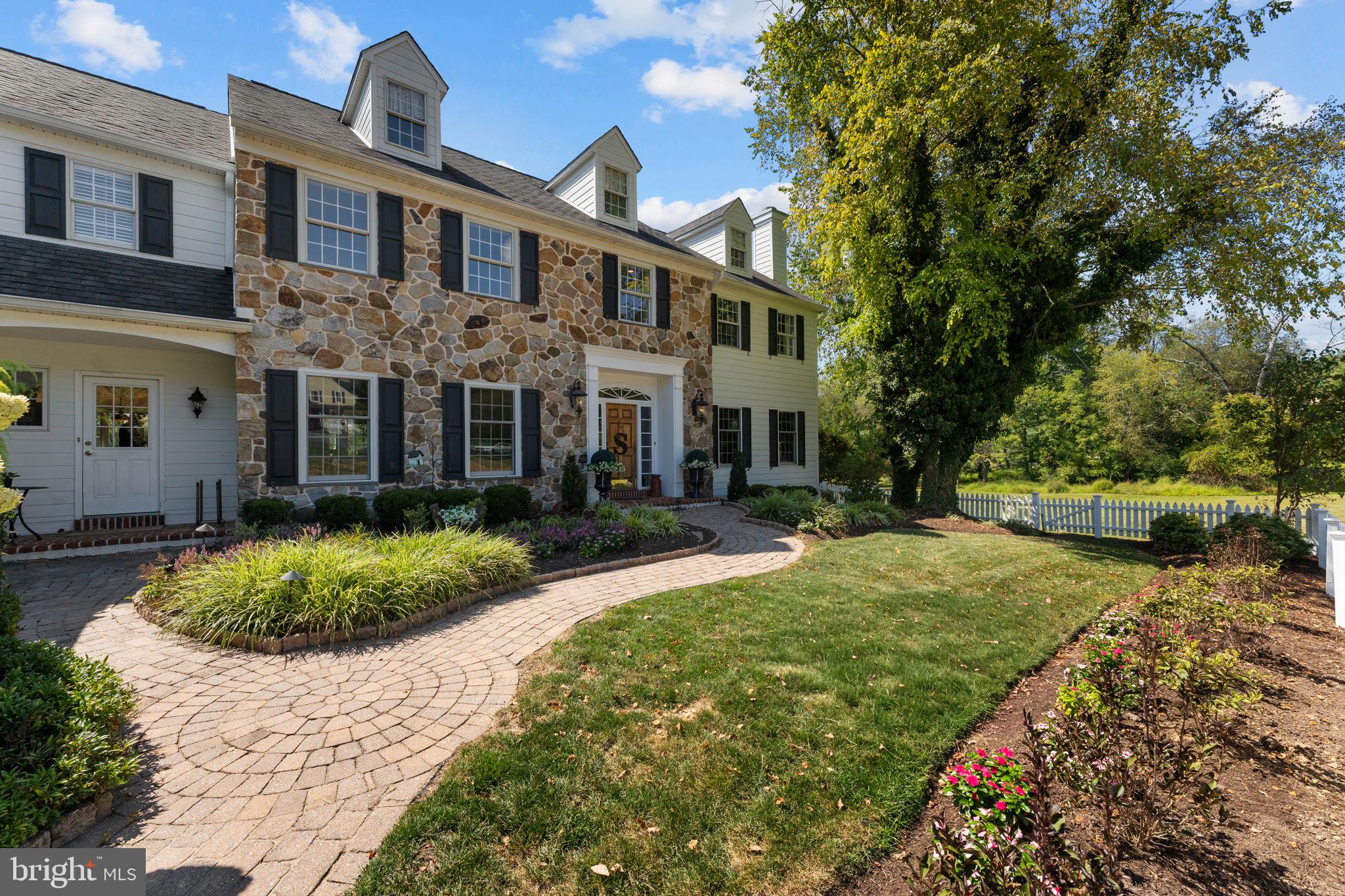 740 Monument Road Malvern, PA 19355 - Photo 4 of 51 a front view of a house with a garden