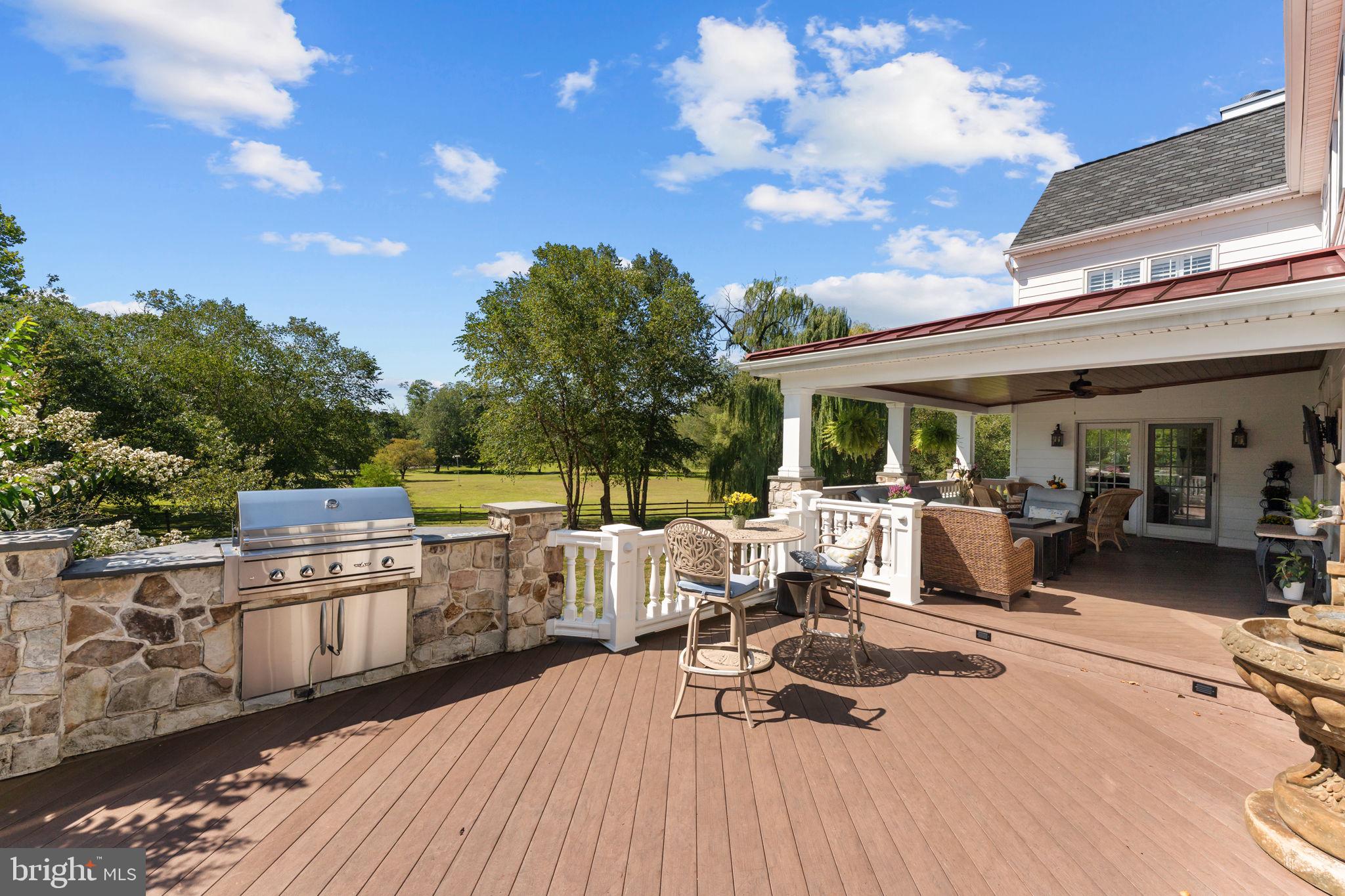 740 Monument Road Malvern, PA 19355 - Photo 42 of 51 a view of a patio with table and chairs with wooden floor and fence