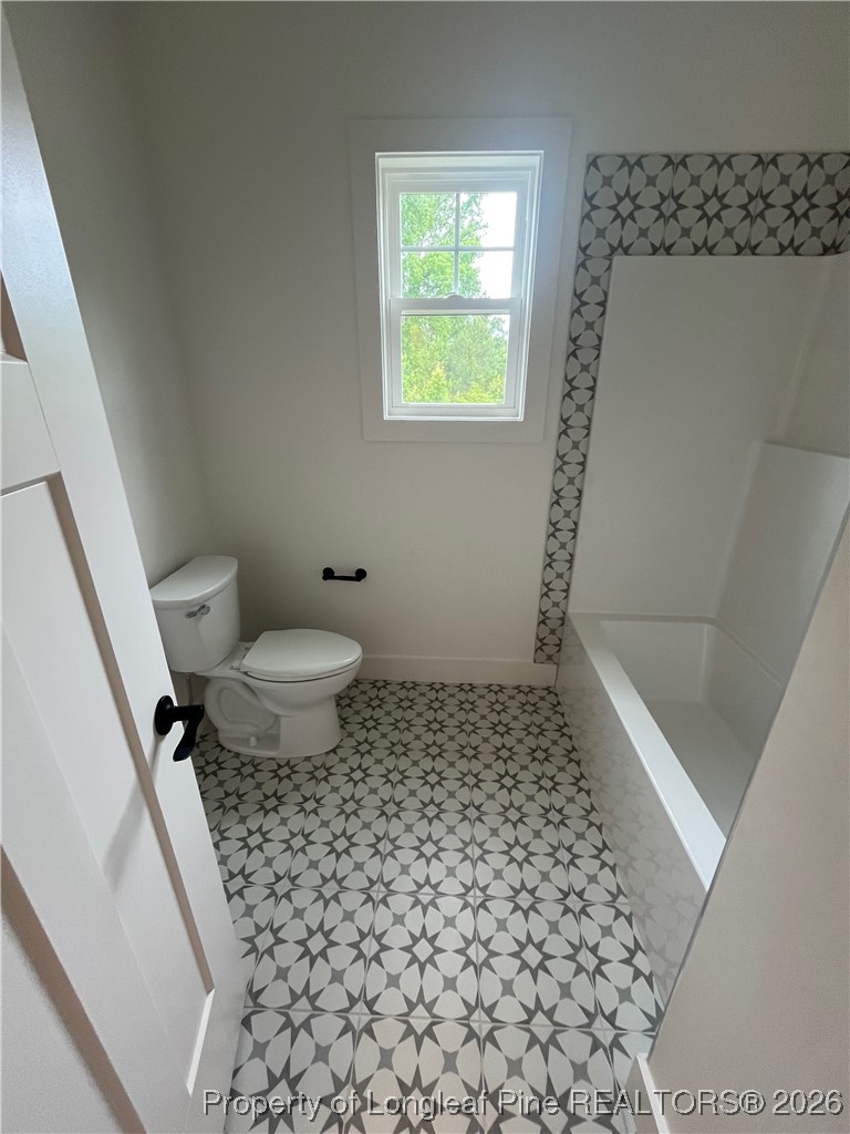 115 Keyser Street Aberdeen, NC 28315 - Photo 13 of 17 a bathroom with a granite countertop sink a toilet and a shower