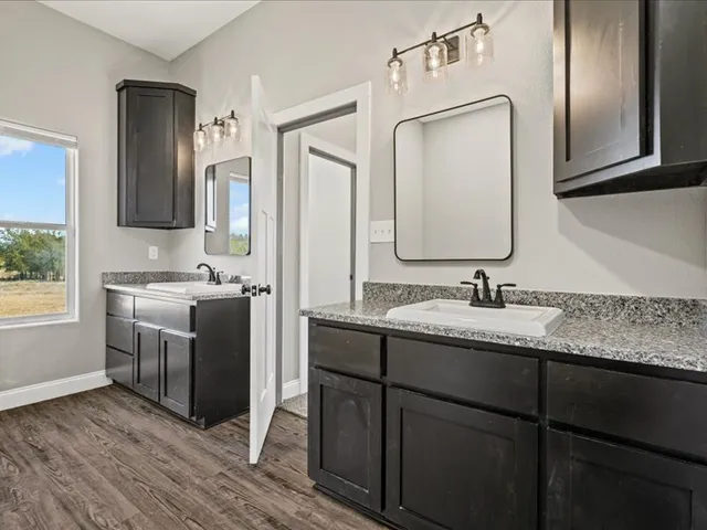 a bathroom with a double vanity sink and mirror