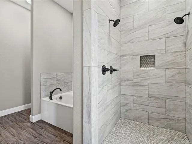 a bathroom with a bathtub and shower