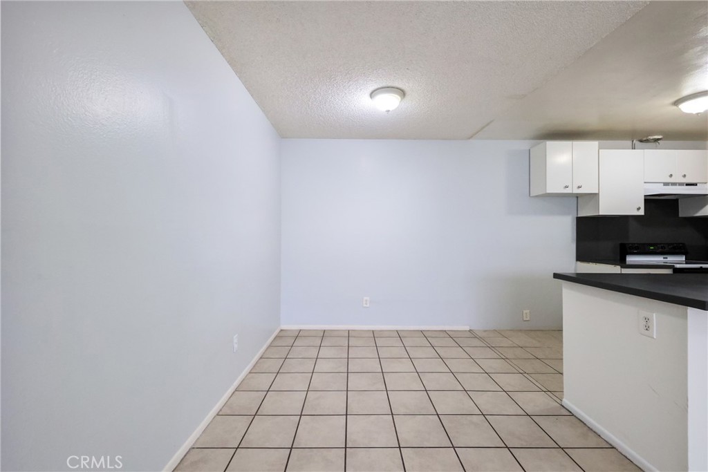 2521 West Sunflower Avenue, Unit R1 Santa Ana, CA 92704 - Photo 11 of 38 a view of a kitchen with white cabinets and appliances