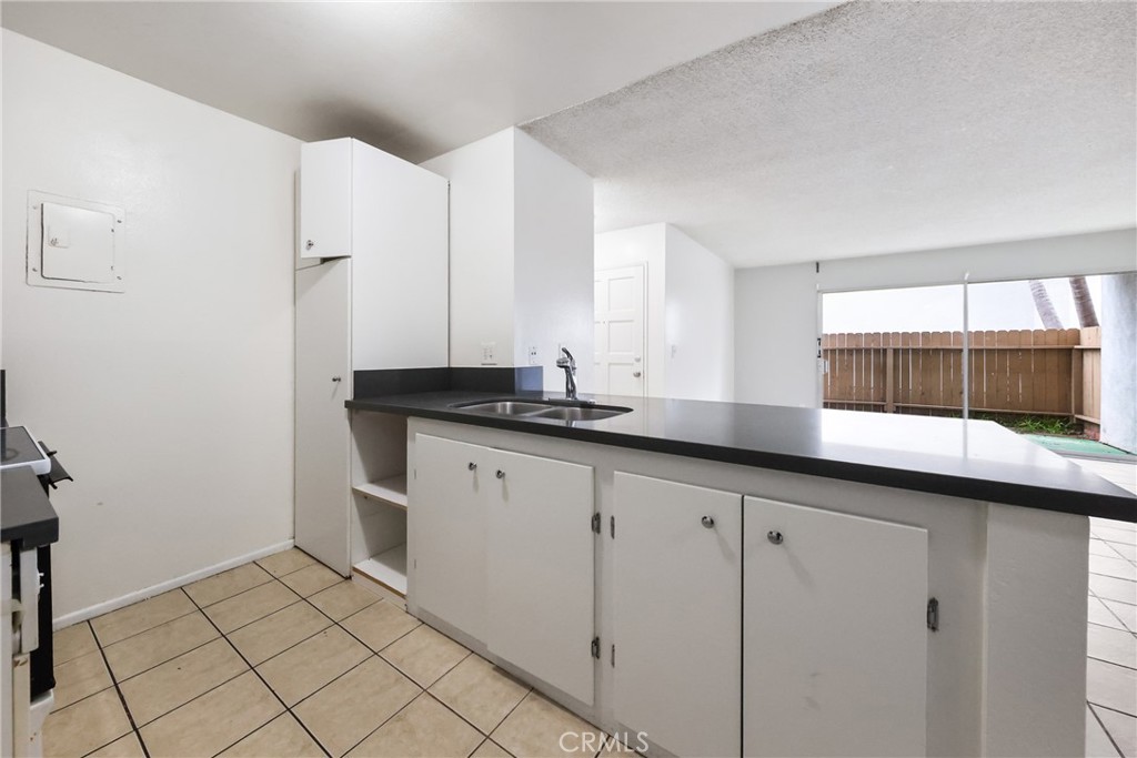 2521 West Sunflower Avenue, Unit R1 Santa Ana, CA 92704 - Photo 14 of 38 a kitchen with a sink and cabinets