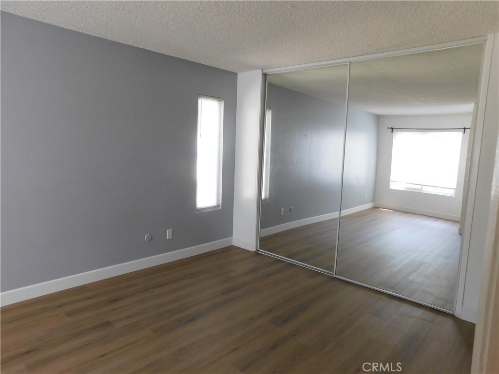 2521 West Sunflower Avenue, Unit R1 Santa Ana, CA 92704 - Photo 18 of 38 Primary Bedroom with large wardrobe