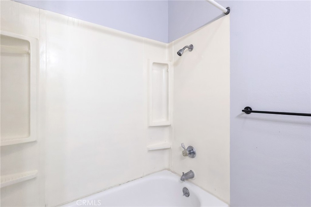 2521 West Sunflower Avenue, Unit R1 Santa Ana, CA 92704 - Photo 19 of 38 a bathroom with a bathtub and a shower