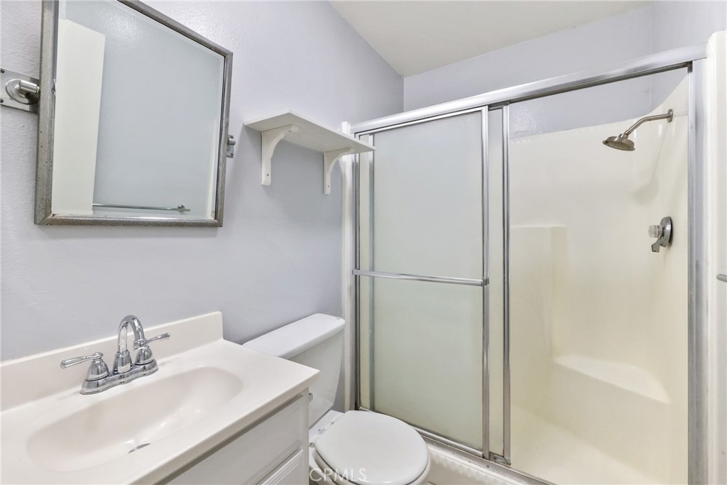 2521 West Sunflower Avenue, Unit R1 Santa Ana, CA 92704 - Photo 24 of 38 a bathroom with a sink toilet and shower