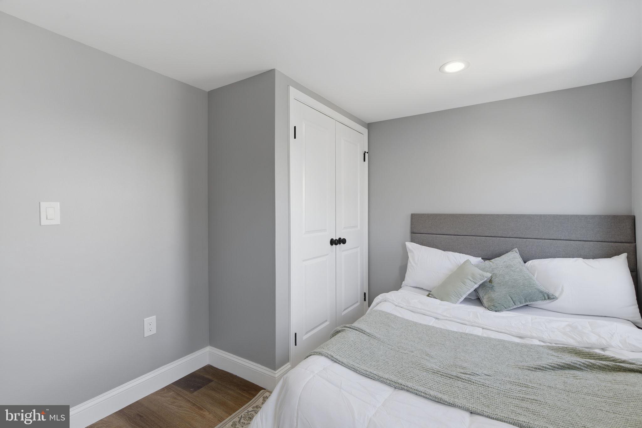 1600 Federal Street Baltimore, MD 21213 - Photo 18 of 31 a bedroom with a bed and wooden floor